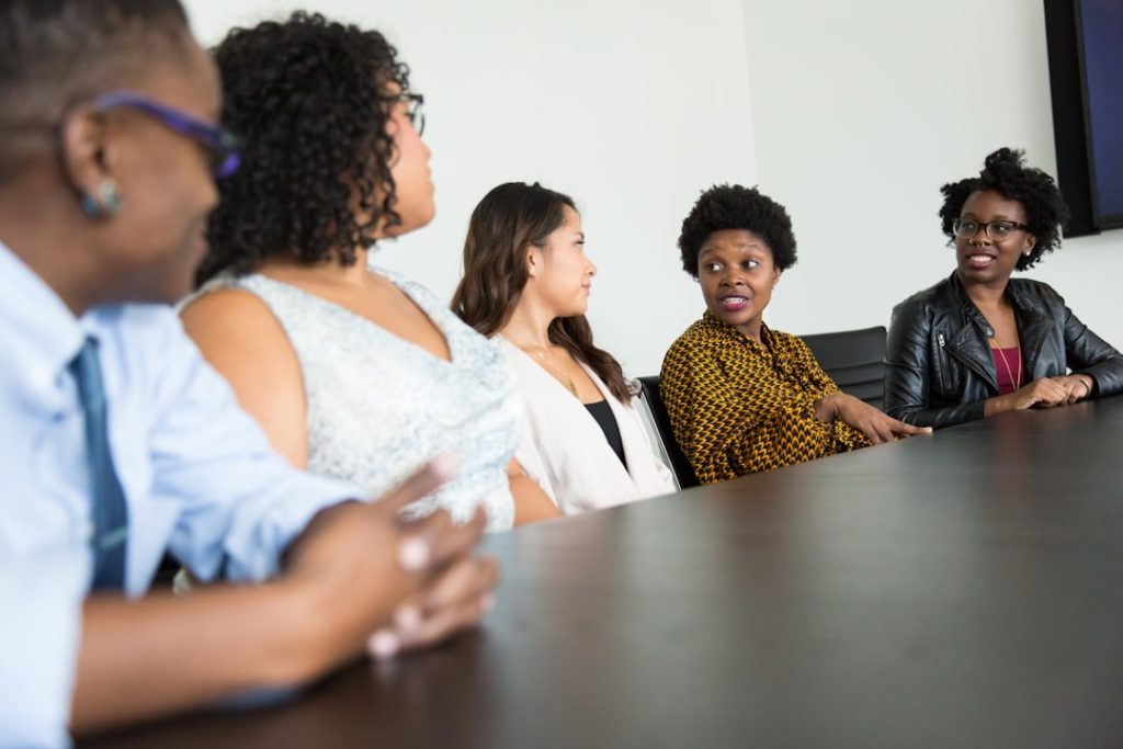 Black professionals and community members meeting around a table